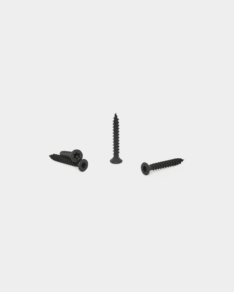 WoodUpp image showing four black WoodUpp countersunk wood screws with Phillips heads and coarse threads; one screw stands upright while three lie flat on a clean white background, highlighting their tapered points, flat countersunk heads and dark corrosion-resistant finish for decking and exterior timber projects.