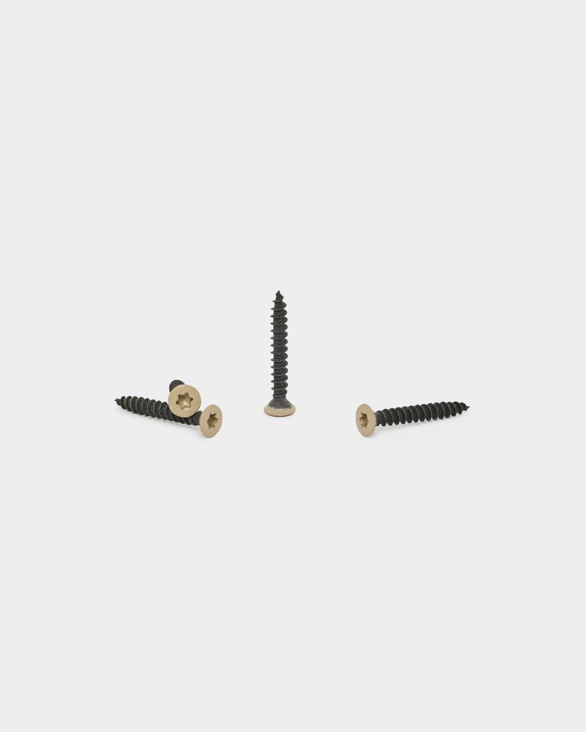 WoodUpp product photo showing four coated wood screws: gold-colored, countersunk star-drive heads with black, coarse threaded shanks. Three screws lie flat while one stands upright on a clean white background, displaying thread profile and head detail for installation in timber or composite decking.