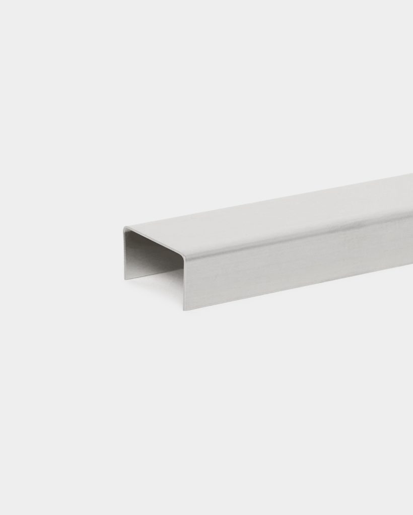 WoodUpp stainless steel U-channel profile displayed on a white background: a brushed, rectangular U-shaped metal channel with rounded internal corners, designed as an edge trim or connector for decking and facades. The single long, hollow rail is shown diagonally, highlighting its smooth finish and clean bends.