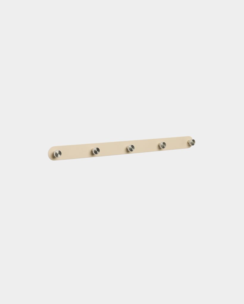 WoodUpp five-hook wall rail displayed against a light background: a slim, rounded rectangular beige wooden backplate with five evenly spaced brushed metal cylindrical knobs for hanging coats or bags. Minimal, modern design with subtle matte finish and stainless-steel pegs suitable for hallway or entryway.